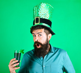 St Patrick's Day. Bearded man in leprechaun hat. Portrait of scared man. Clover in beer. Bearded...