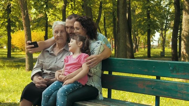 Happy family in the park. Generations of the family are photographed.
