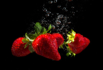 Strawberries with water bubbles and black background