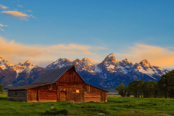 Fototapeta na wymiar This abandoned, vintage barn in Mormon Row has the Grand Tetons in the background. Located in Jackson Hole, Wyoming, it is listed on the National Register of Historic Places.