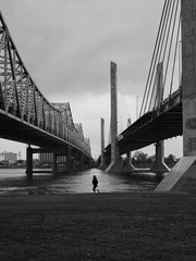 Woman running between two bridges
