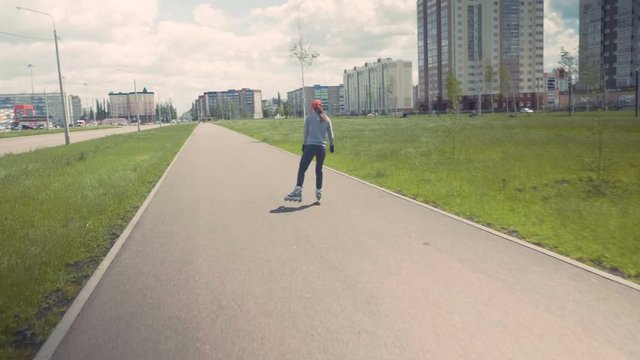 Beautiful girl on roller skates with the camera. The girl shoots herself on Gh5