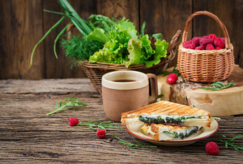 Panini sandwich with cheese and mustard leaves. Morning coffee. Village breakfast