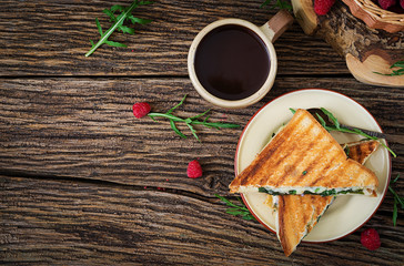Panini sandwich with cheese and mustard leaves. Morning coffee. Village breakfast. Top view. Flat lay