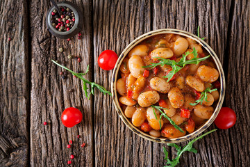 Steamed white beans with vegetables in tomato sauce. Vegan food. Asian meal. Top view. Flat lay.