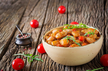 Steamed white beans with vegetables in tomato sauce. Vegan food. Asian meal.