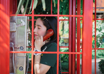 Lady phone in red public telephone booth vintage old