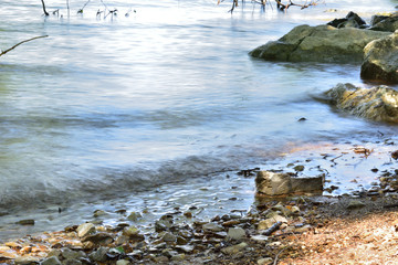 Long exposure shot of some small waves coming off a lake