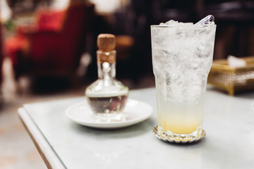 Soda mocktail served with syrup in glass bottle.