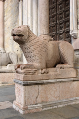 the stone lion statue in front of Parma Cathedral (Duomo), Italy
