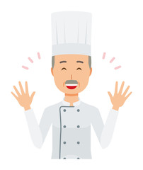 An elderly male chef wearing a cook coat is spreading his hands