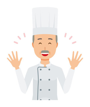 An elderly male chef wearing a cook coat is spreading his hands