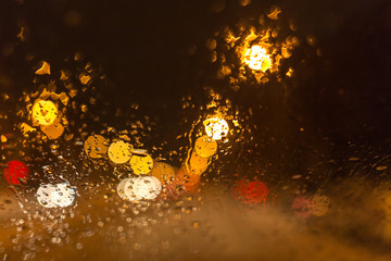 Snow with droplets on the car glass at night