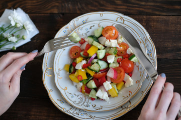 flowers, wine and salad from vegetables on old wooden table