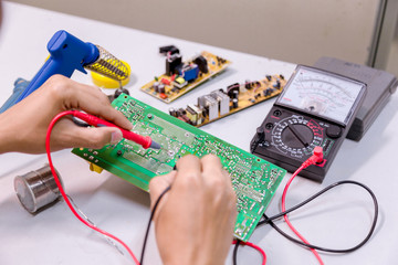 Close up of the hand men hold tool repairs electronics manufacturing Services,Repair of electronic devices, tin soldering parts.