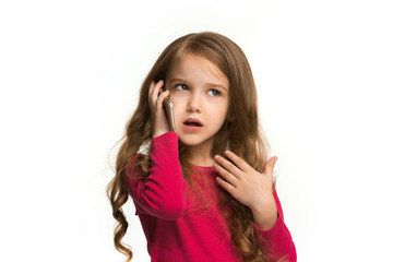 Fototapeta premium The happy teen girl standing and smiling against white background.