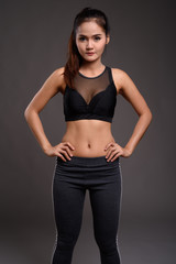 Fototapeta na wymiar Young beautiful Asian fitness woman with slim waist