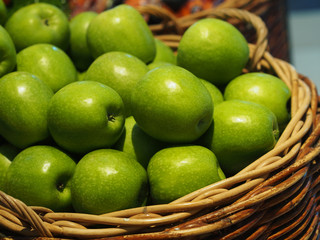 bulk fresh green apple fruits in basket for sale in supermarket