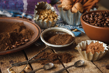 Roasted black and green coffee beans and ground coffee in the plate