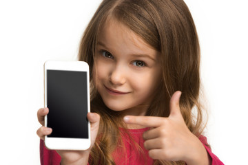 The happy teen girl standing and smiling against white background.