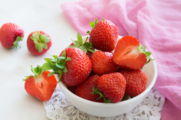 ripe red strawberries in a white bowl