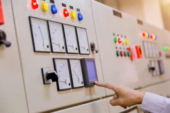 Engineer working on checking and maintenance electrical equipment engineer checking status switchgear with checklist System ready.