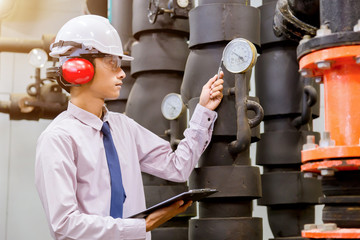 Engineer checking Condenser Water pump and pressure gauge , chiller water pump with pressure...