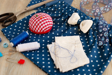 Obraz premium Sewing skirts for girls. Sew clothes for children from cloth with a pattern in polka dots. Tailoring scissors and objects for sewing.