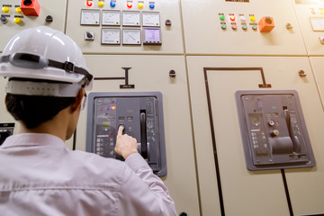 Control Room Engineer. Power Plant Control Panel. Engineer standing in front of the control panel...