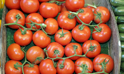 box of red tomatoes at a local market stall