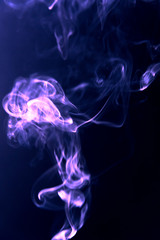 Texture of violet blue  smoke clubs on a dark background. 