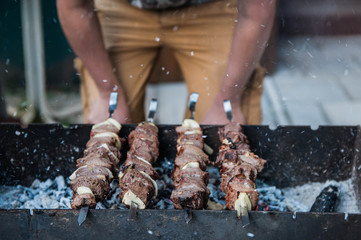 Appetizing barbecue shish kebab fried on charcoal grill outdoor