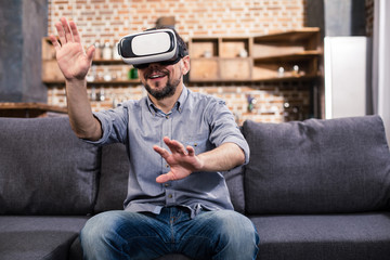 Joyful man testing VR device