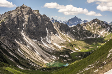 Beautiful mountain Lake Lache  in Tannheimer Tal high valley with mountain refuge Landsberger Hut in the background, Tyrol, Austria