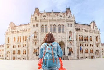 Foto auf Acrylglas Happy asian casual woman student enjoying great view of the Parliament building in Budapest city, travel in Europe concept © EdNurg