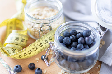 fresh blueberries in a clear glass jar, Breakfast ingredients blueberries and oatmeal. healthy Breakfast concept, selective focus
