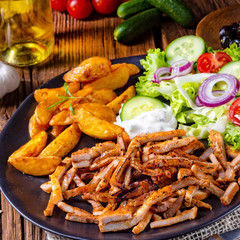 Rustic gyros plate it green salad and potato wedges