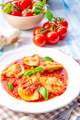 Delicious pasta - ravioli in tomato sauce with basil
