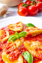 Delicious pasta - ravioli in tomato sauce with basil
