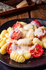 delicious gnocchi with gorgonzola cream sauce and cherry tomatoes