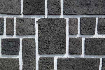 Wall made of blocks of black basalt