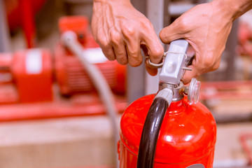 Close up Fire extinguisher and pulling pin on red tank.
