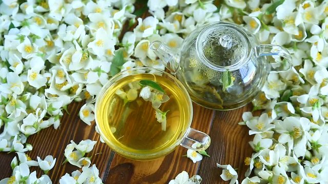 Tea with jasmine flowers in a glass teapot