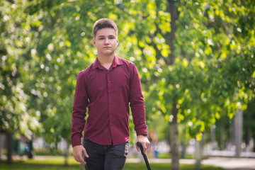 Young man standing, leaning on his cane