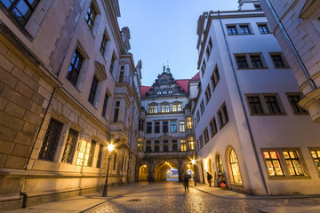 Night view of illuminated narrow street with old historic buildings of Dresden city, Germany.