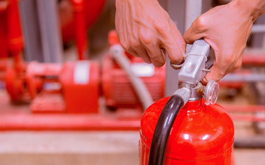 Close up Fire extinguisher and pulling pin on red tank.