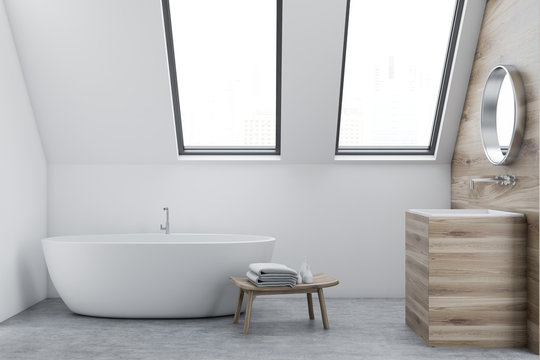 Attic white bathroom interior, sink and tub
