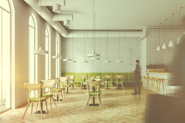 Industrial style cafe interior flower beds, people