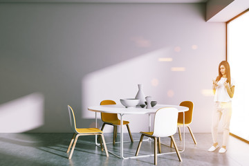 Round table dining room, woman with smartphone