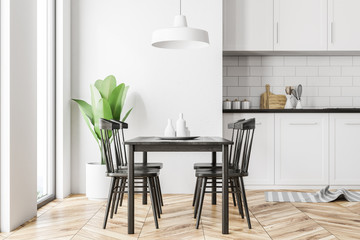 White kitchen interior, black table, side view